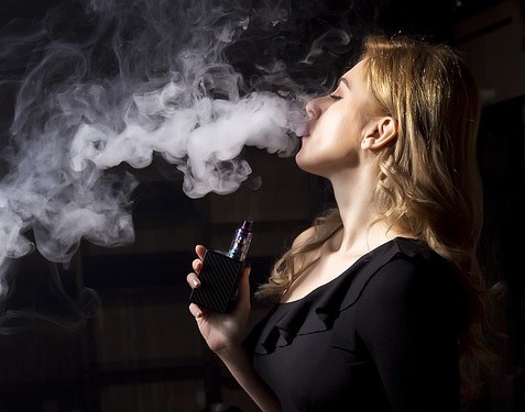 woman vaping e-cigarette