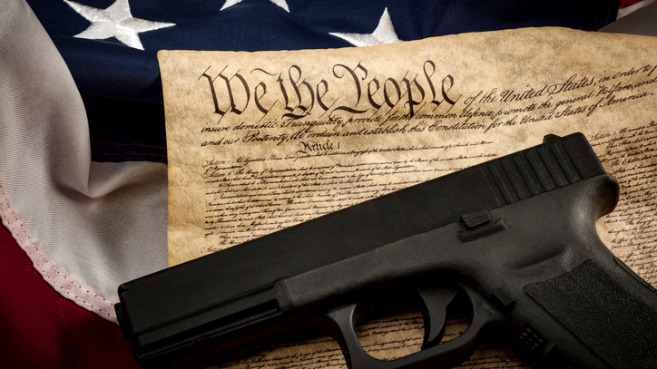 American constitution, USA flag and a handgun