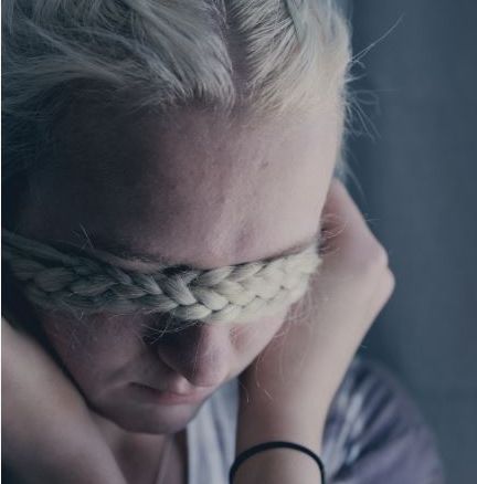 Girl with hair braids across eyes