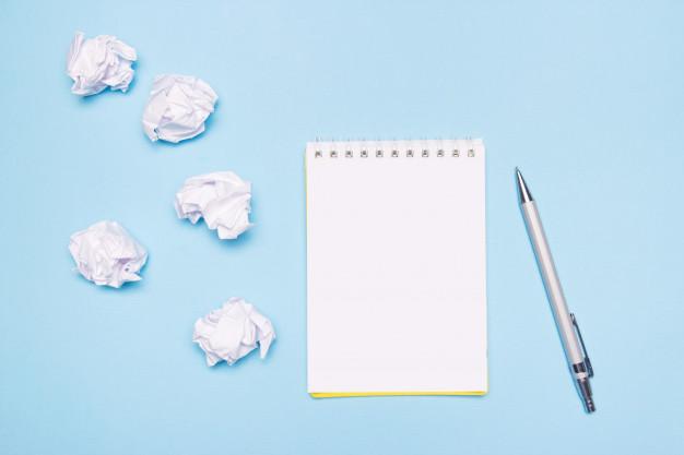 Notepad and crumpled up drafts