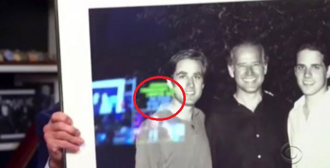 Teleprompter reflected in the glass of a photo in Bidens basement bunker