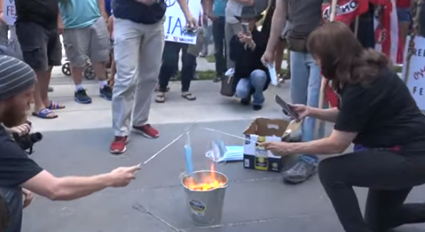 Mask burning party outside Ohio city hall