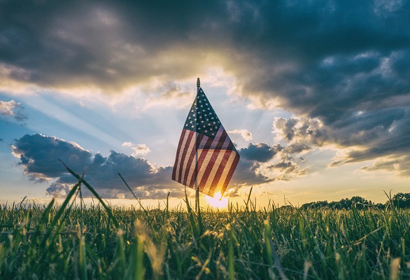America flag sunrise field Photo by Aaron Burden on Unsplash