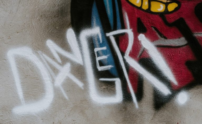 danger grafitti original Photo by Ashkan Forouzani on Unsplash
