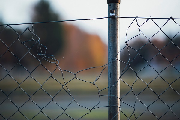 damaged chain link fence Photo by Markus Spiske on Unsplash