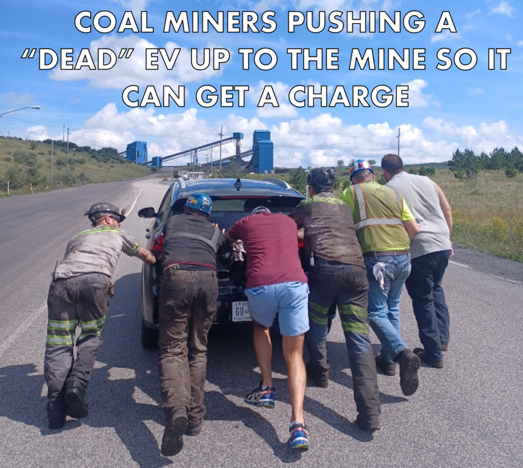 Coal miners pushing an electric car up to the mine for a charge