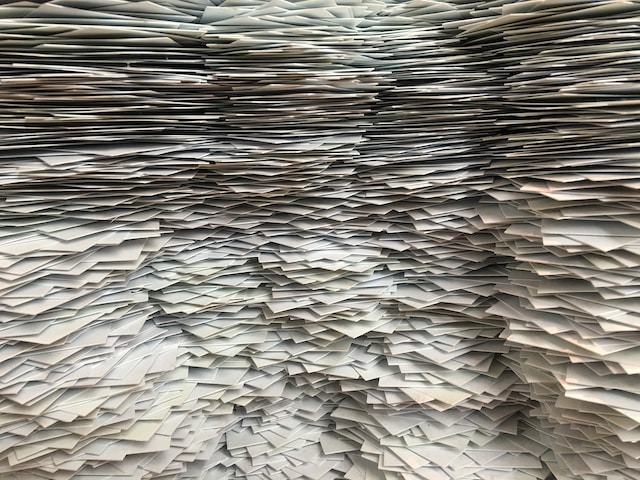 stacks of pages paper cards Photo by Christa Dodoo on Unsplash