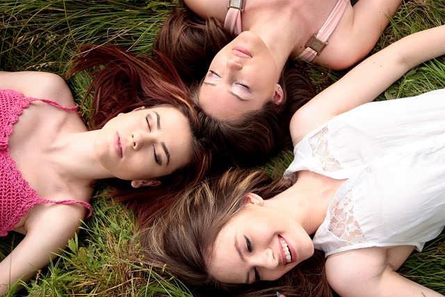 young women laying down smiling