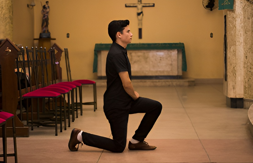 man in church genuflecting
