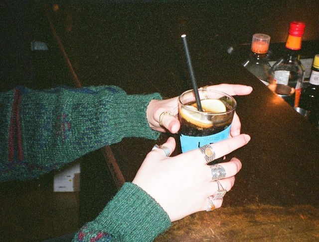 Woman at a bar with a mixed drink