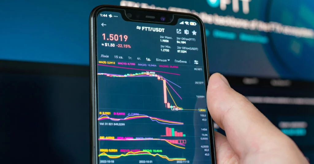 Man-holding-phone-with-FTX-logo-1024x536