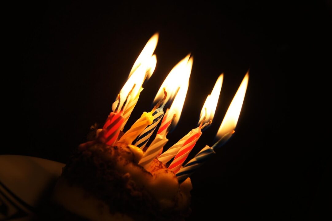 cupcake with lit candles on it.