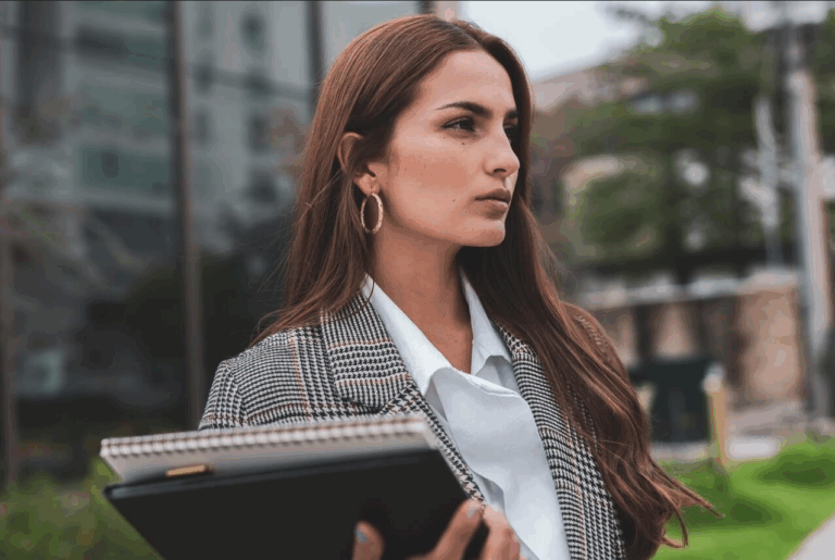 brunette woman with note books in business attire