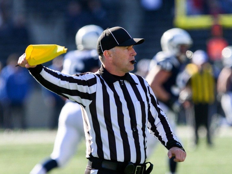 Referee with a penalty flag american football
