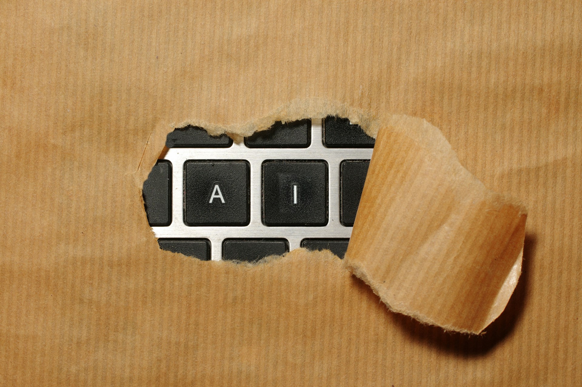 AI keys viewed through torn bronw paper