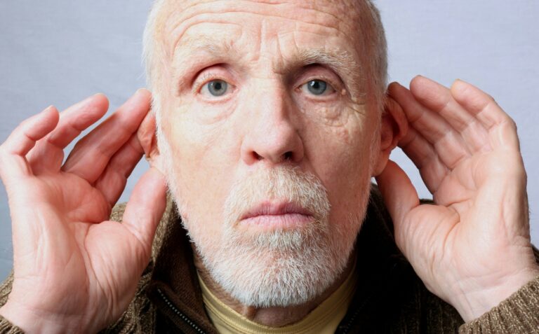 older man ears forward to listen