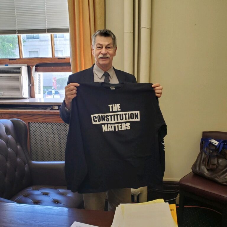 Gary Daniels holding a t-shirt