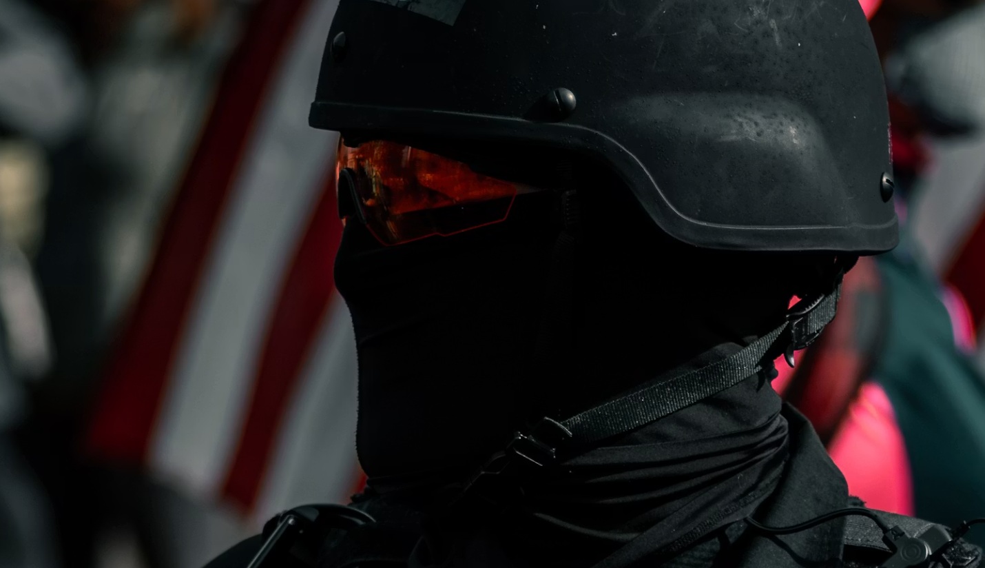 masked officer or agent in riot gear