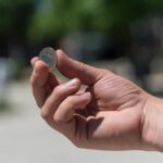 hand with a coin in it about to be flipped