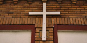 white cross on a brick building