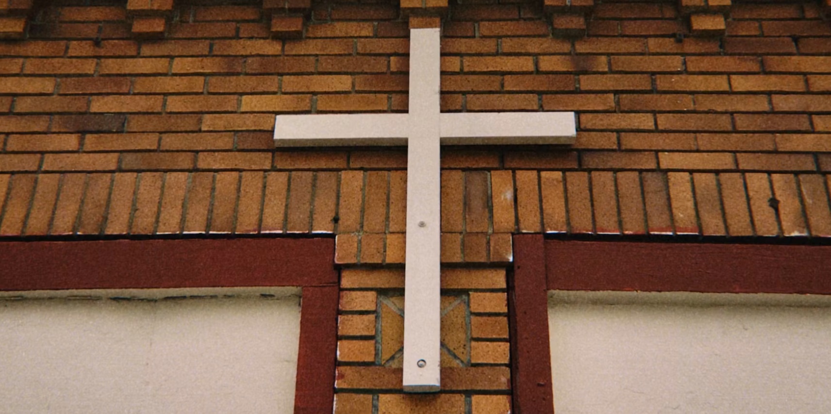 white cross on a brick building